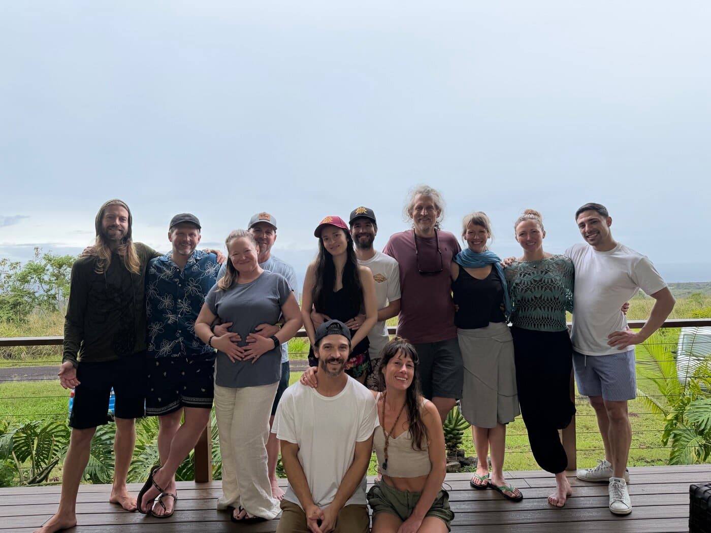 Full Sacred Ways Hawaii retreat group on the sanctuary deck overlooking the Big Island coast